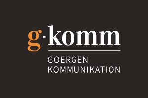 Logo von Goergen Kommunikation Logo von Goergen Kommunikation in schwarz, weiß und orange.